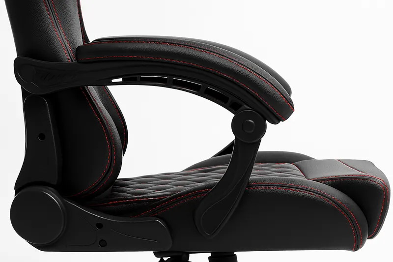 Close-up side view of a black faux leather gaming chair with red stitching, showcasing padded armrest, lumbar support, and textured seat on a clean white background.